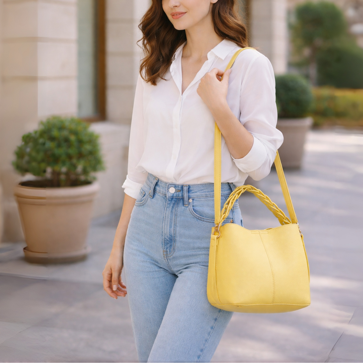 Woman holding a yellow handbag in an urban setting